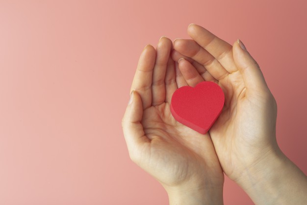 corazon-manos-mujer-sobre-fondo-color-fondo-san-valentin-14-febrero-amor_90380-2172.jpg